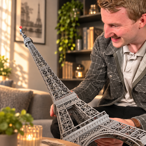 A guy holding the assembled Eiffeltower which fills the screen